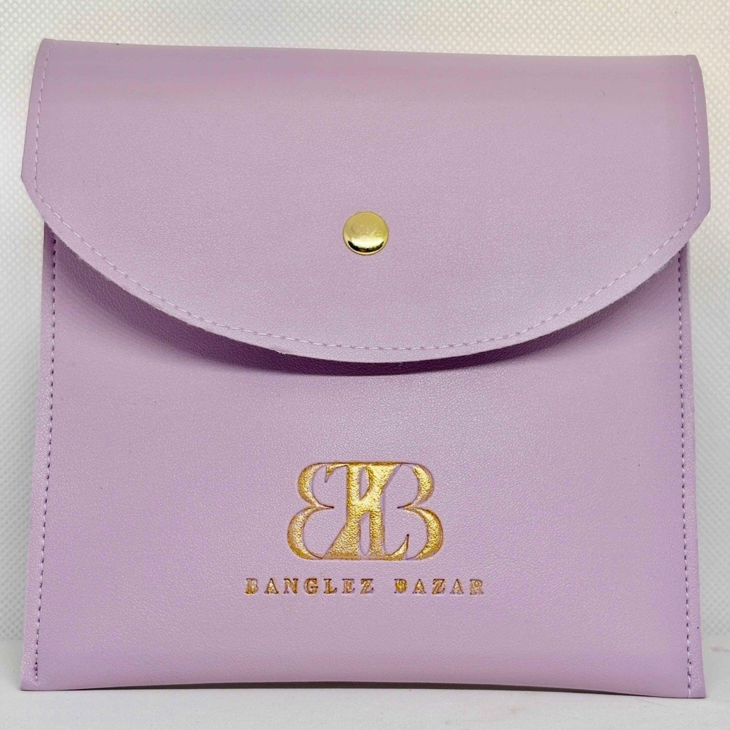 purple faux- leather packaging envelope with snap button