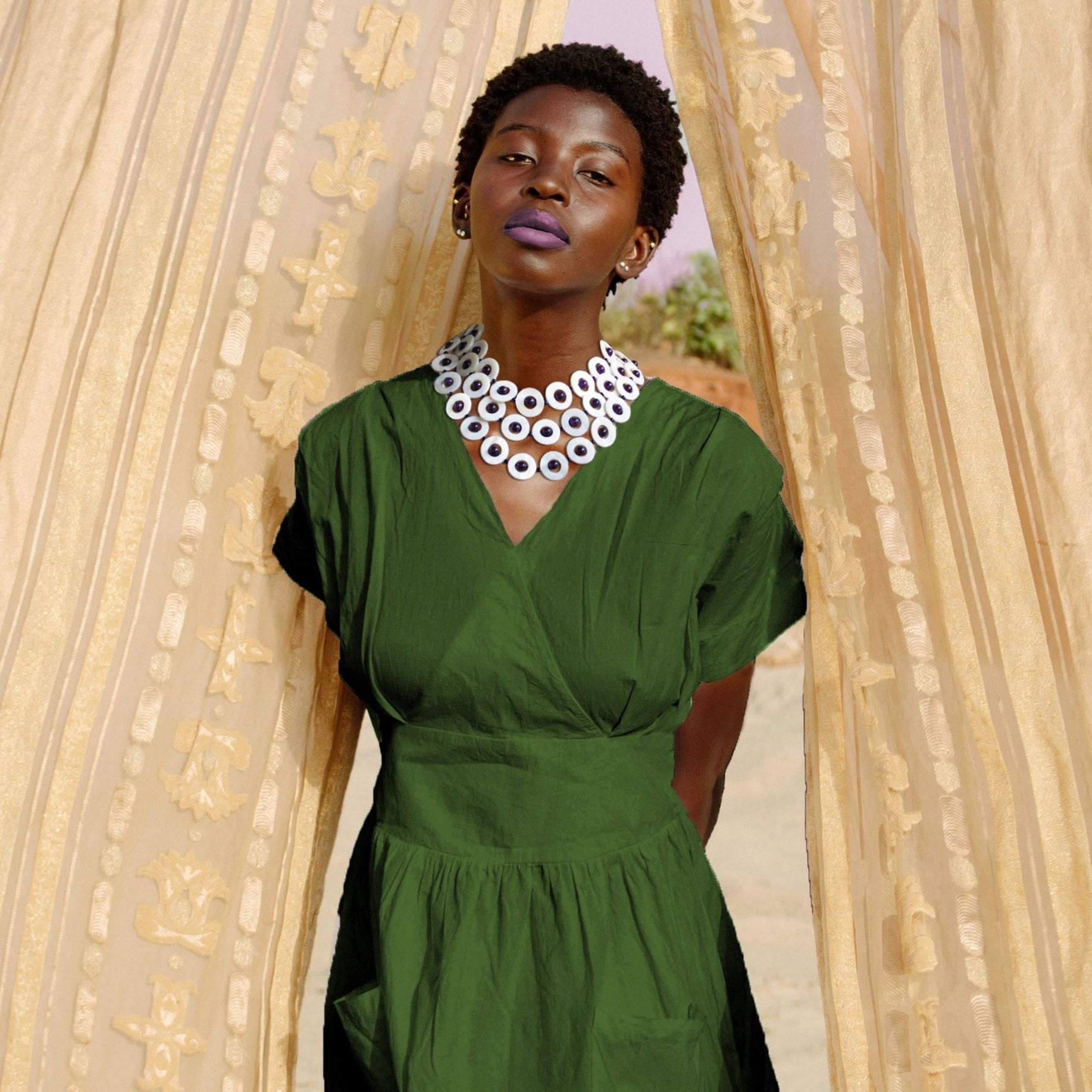 Model wearing green dress with Amethyst shell necklace on